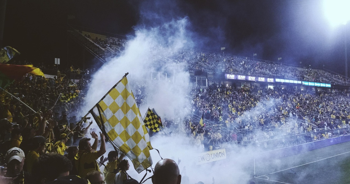 football stadium fans cheering flags